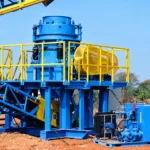 Blue cone crusher installation with yellow access railings, AI-retouched from a licensed site photograph